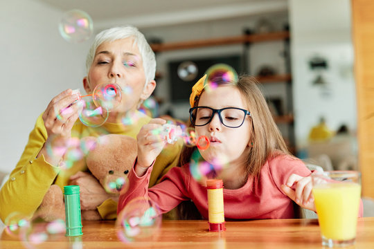 grandchild granddaughter grandma grandmother girl love family blowing soap bubble