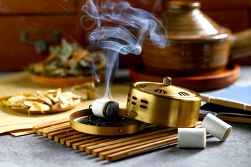 Obraz na płótnie Canvas Chinese copper moxibustion box with smoke on bamboo 