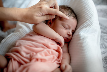 Newborn girl sleeping in the crib
