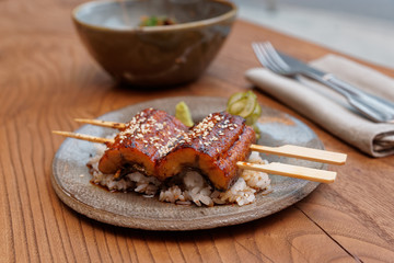 Unagi eel with rice on table