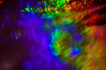 Dark abstract background with overflow, multicolored, rainbow bokeh and highlights.