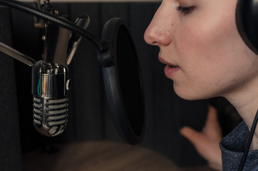 young woman speaking into a microphone