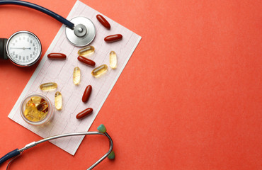 Pills, vitamins, stethoscope, cardiogram, on the table.Copy space.