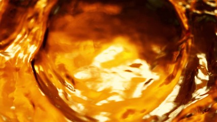 Super Slow Motion Shot of Rippling Golden Liquid at 1000fps.