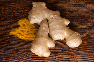 Fresh and organic ginger root and turmeric powder