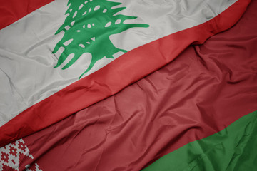 waving colorful flag of belarus and national flag of lebanon.
