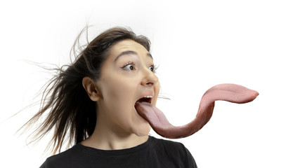 Smiling girl opening her mouth and showing the long big giant tongue isolated on white background....