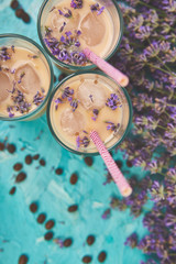 Summer drink iced coffee with lavender in glass and coffee beans on blue background. Good Morning concept. Baeutiful ice coffee.