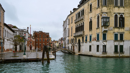 View of the ancient architecture of Venice from the Grand Canal in the rain.