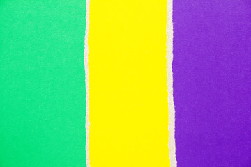 Green, purple and yellow torn cardboard paper texture background. Copy space for text message.