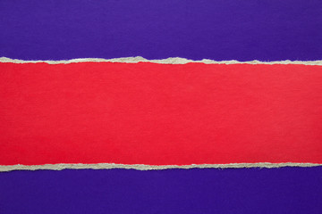 Torn red stripe of cardboard on purple blue paper texture background. Can be used for text message.