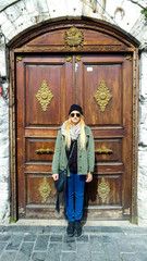 Fototapeta na wymiar Caucasian woman standing in front of ornate door, Istanbul, Turkey