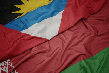 waving colorful flag of belarus and national flag of antigua and barbuda.