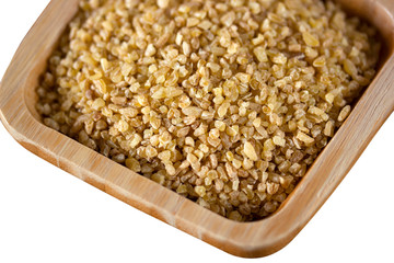 raw wheat grains in wooden plate