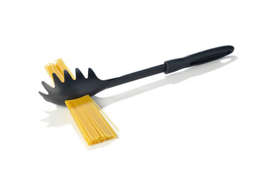 Life hack, measuring one serving of pasta with spaghetti spoon isolated on white background.    