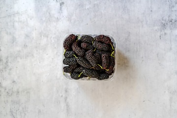 Organic Dark Black Ripe Mulberries in Plastic Box Package for Sale / Morus Fruit.