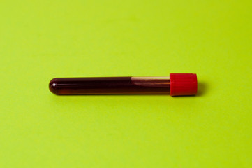 Test tube with blood isolate on a green background