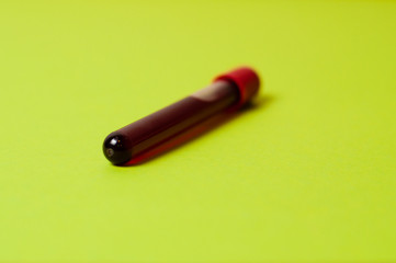 Test tube with blood isolate on a green background
