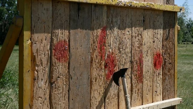 ax throwing to wooden fence