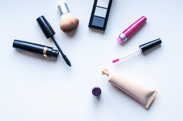 Close up view of various brushes and cosmetics for applying makeup on table