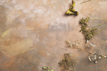 Dried flowers on decorative brown backdrop.