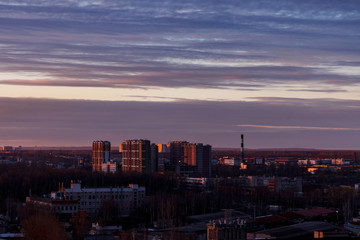 Aerial photography of the evening Industrial district of a large Russian city with warehouses, warehouses, offices and buildings. Beautiful sky at sunset.