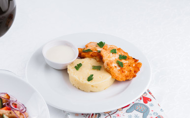 
dinner menu, feast and chicken cutlet with salad and red wine in combination with a tablecloth, tableware on the table