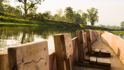 Wooden stools in wooden boat on a river in Chitwan National Park, Nepal