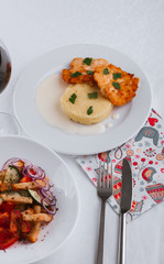 
dinner menu, feast and chicken cutlet with salad and red wine in combination with a tablecloth, tableware on the table