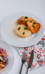 
dinner menu, feast and chicken cutlet with salad and red wine in combination with a tablecloth, tableware on the table