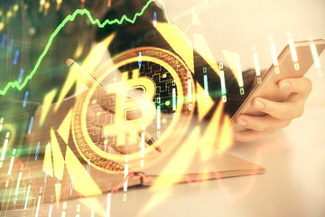Double exposure of blockchain business sketch hologram and woman holding and using a mobile device.