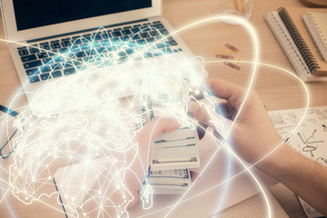 Multi exposure of financial theme drawing hologram and USA dollars bills and man hands. Business...