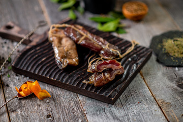 Beef jerky on wooden board with zest lemon spices salt