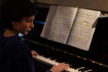 young musicist playing on his piano