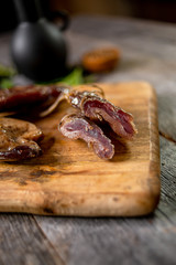Beef jerky on wooden board with zest lemon spices salt