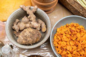 hand cooking turmeric and ginger for jamu herbal drink