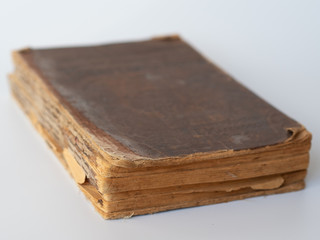 Old tattered book on white background.