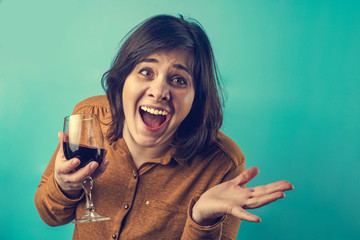 a drunk funny woman with dark hair. the girl laughs inappropriately with a glass of wine. excessive...