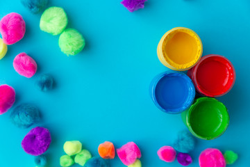 colorful paint buckets on a colored background and plush balls