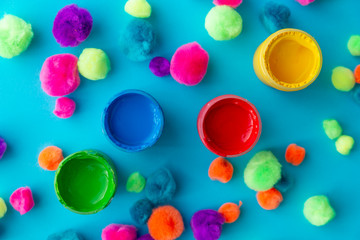 colorful paint buckets on a colored background and plush balls