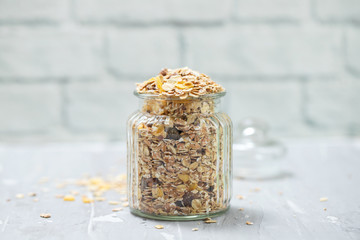 muesli in glass jar on ceramic background