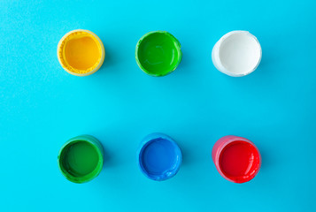 colorful paint buckets on a colored background