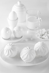 milk eggs marshmallows and sugar on a white table