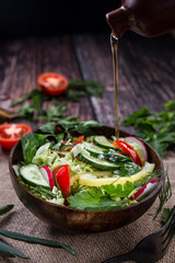 salad with tomato and cucumber drizzled with oil