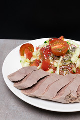 boiled cutting raw tongue with salad on white plate