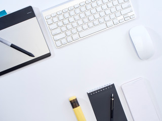 Top view of white office desk.