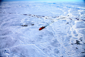 Red icebreaker in the middle of Arctic ocean