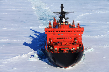 Red icebreaker in the middle of Arctic ocean