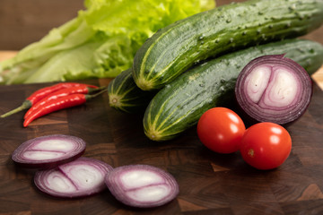 vegetables and greens on wooden cutting board
