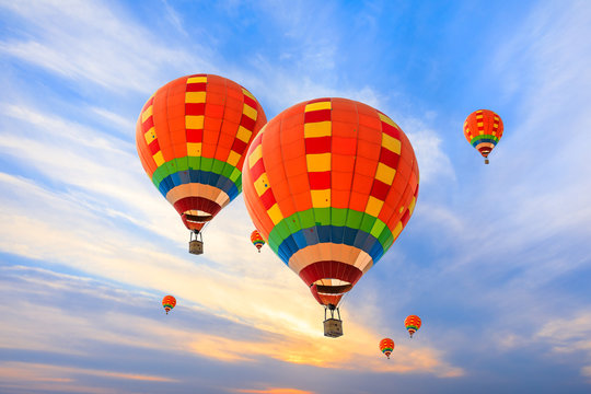 Hot air balloon floating in the sky at sunset.